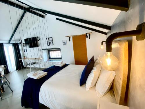 a bedroom with a large bed with blue and white pillows at Villa Rio by Valada Village in Valada