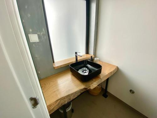 a bathroom with a black sink and a mirror at Villa Rio by Valada Village in Valada