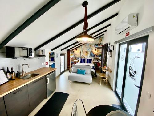 a kitchen and living room with a vaulted ceiling at Villa Rio by Valada Village in Valada