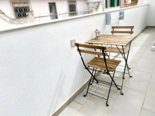 a wooden table and chair on a balcony at Villa Rio by Valada Village in Valada