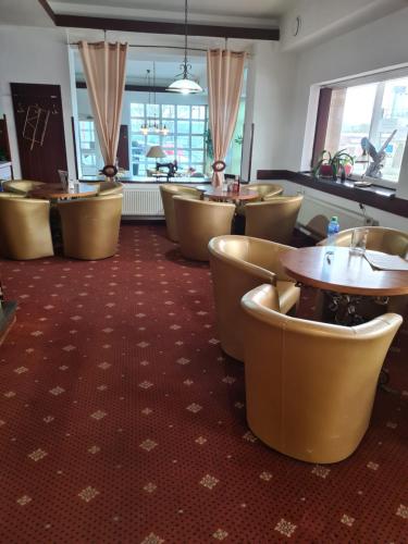 a restaurant with rows of chairs and tables at Hotel Montenegro in Bruntál