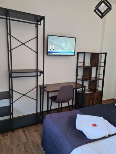 a bedroom with a bed and a desk and a table at Hotel Montenegro in Bruntál