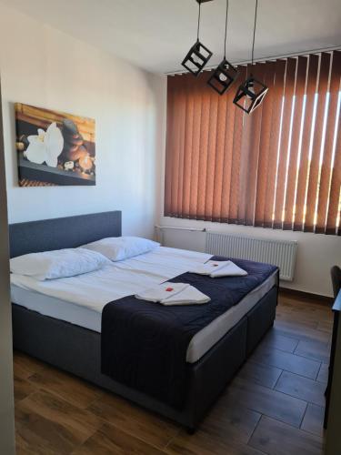 a bedroom with a large bed with towels on it at Hotel Montenegro in Bruntál