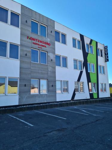 an empty parking lot in front of a building at Hotel Montenegro in Bruntál