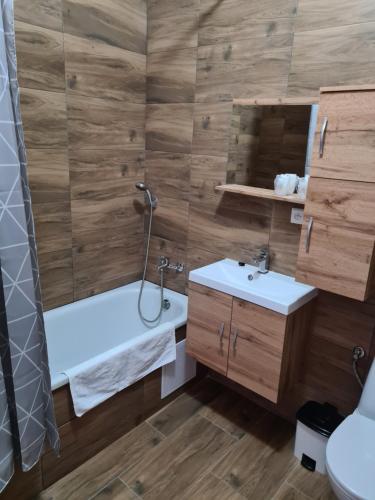 a bathroom with two sinks and a shower and a tub at Hotel Montenegro in Bruntál