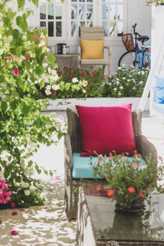 a couch on a porch with flowers on it at Fiyala Homestay in Feydhoo