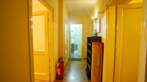 a hallway with a room with a fire hydrant and a refrigerator at Private cozy room 2 with shared kitchen in appartment in Belgrade