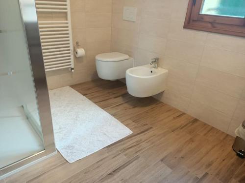 a bathroom with a toilet and a sink at L'incanto home in Bologna