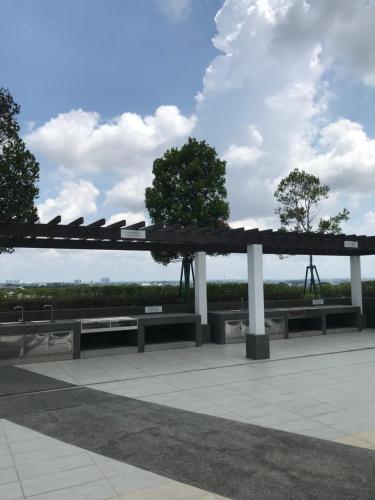 a pavilion with benches and trees in a park at Homestay SKS Apartment Larkin Johor Bahru in Johor Bahru