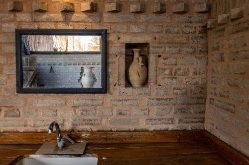 a brick wall with a window and a sink at Ras Hasita in H̱aẕeva