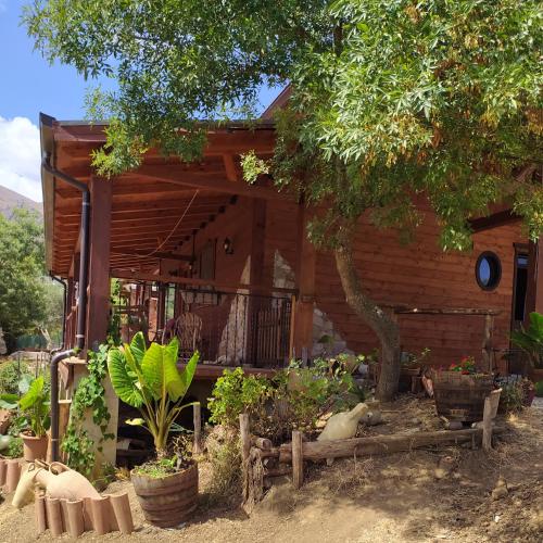 a wooden house with plants in front of it at Room in Casa Castiglia a Woodhouse with Beautiful View close Madonie Park in Castelbuono