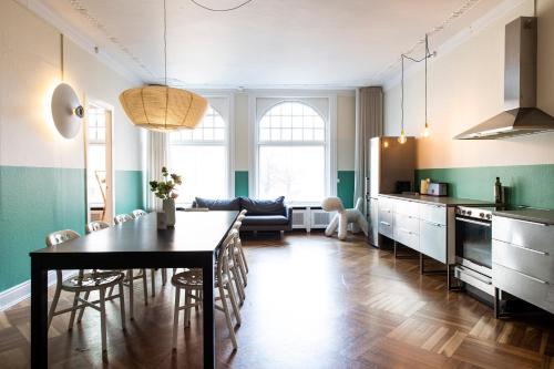 a kitchen and dining room with a table and chairs at On The Mile 1 - Into This Place in Copenhagen