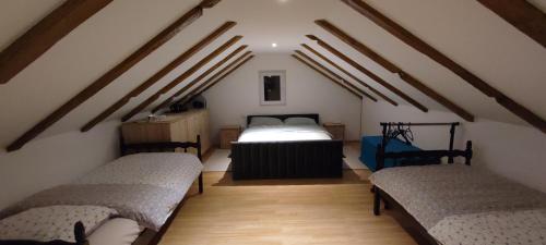 a attic room with two beds and a radiator at Getaway house Loko in Trebinje