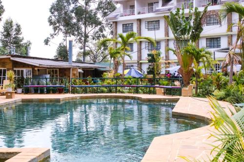 a swimming pool in front of a hotel at Hotel Tobriana in Nairobi
