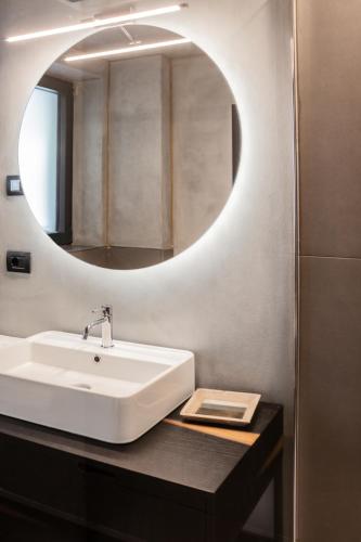 a bathroom with a white sink and a mirror at Gazzi Apartments 'Panoramic & Relaxing' in Arco
