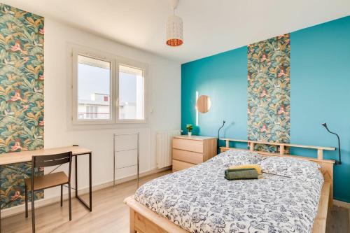 - une chambre avec des murs bleus, un lit et un bureau dans l'établissement Appartement 2 chambres, dernier étage, parking gratuit dans résidence, balcon & coucher de soleil, à Montpellier