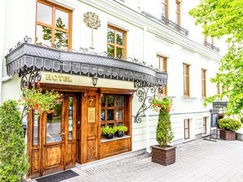 una tienda frente a un edificio con una puerta de madera en Hotel Pod Złotą Różą, en Kielce