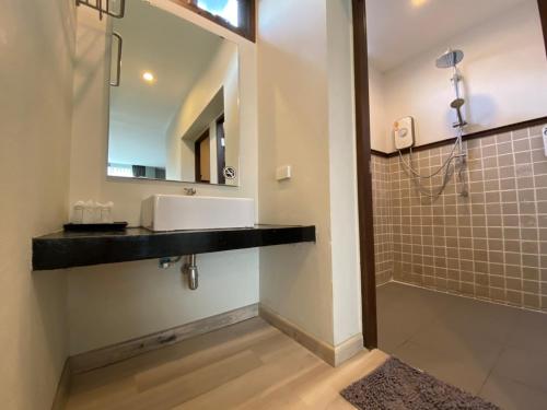 a bathroom with a sink and a mirror at Gord ChiangMai - SHA Extra Plus in Chiang Mai