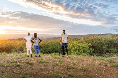 a group of three people standing on top of a hill at Midgard in Khorusepa