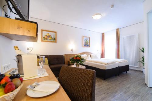 a hotel room with a bed and a dining table at Akzent Hotel Goldner Stern in Muggendorf