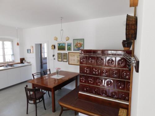 a kitchen and dining room with a table and a cupboard at House 1797 - Charm of Slovenian Vintage in Dob