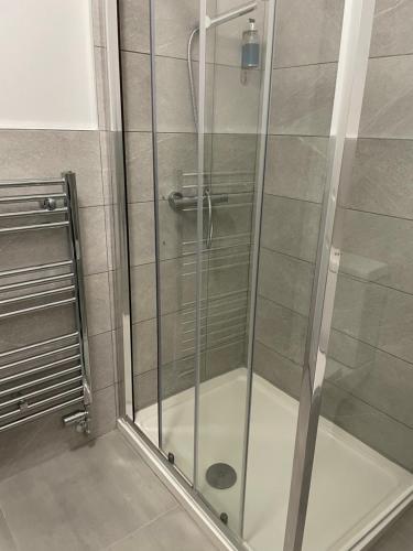 a shower with a glass door in a bathroom at The Banks Of Ury in Inverurie