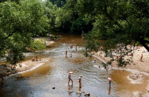 a group of people swimming in a river at Chatka nad Świdrem in Mlądz