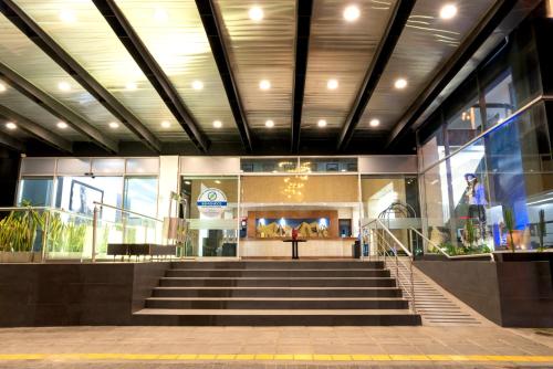 a lobby of a building with stairs in front at Hotel Chicamocha in Bucaramanga