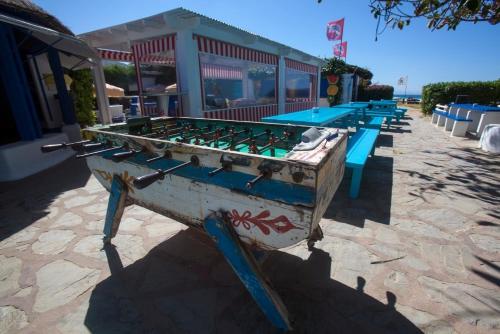a row of picnic tables in front of a restaurant at Bungalows Tangana in Tarifa