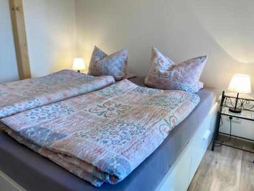 a bedroom with a bed with pillows on it at Ferienwohnung Hof Falke in Suderbruch