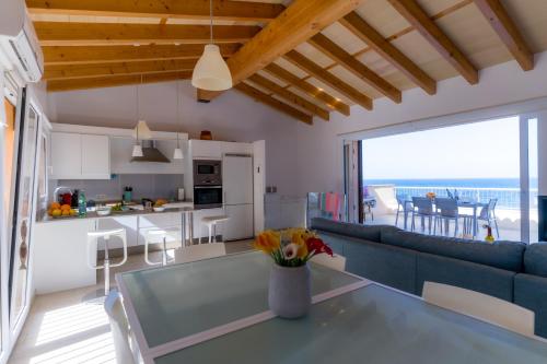 a living room with a blue couch and a table at Can MarSal Puerto Valldemosa in Valldemossa