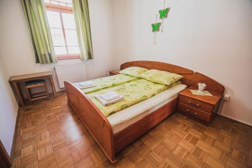 a bedroom with a bed and a wooden floor at Apartments Rombon Klavdij with Free Onsite Parking in Bovec