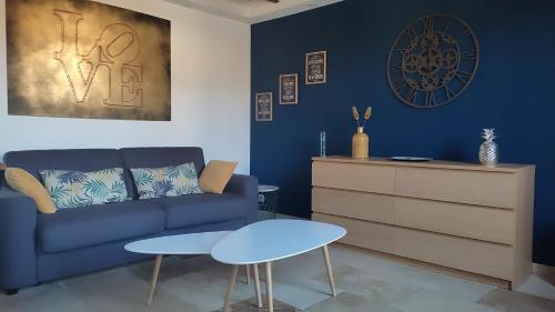 un salon avec un canapé bleu et une table dans l'établissement Loft au coeur d'Avignon, à Avignon