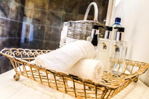 a basket filled with towels on a bathroom counter at Gerald's Gift Guest House in Addo