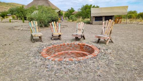a group of chairs and a fire place at Africa Safari Lake Natron Camping in Mtowabaga