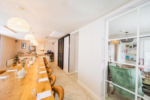 a long dining room with a long table and chairs at Stadsvilla Hotel Mozaic Den Haag in The Hague