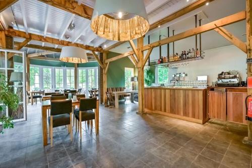 a large kitchen and dining room with a table and chairs at Safari Retreat "Explorer Tents" in Holten