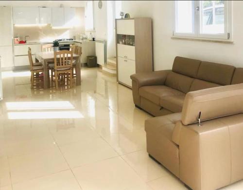 a living room with a couch and a table at Villa“La Salentina” in Castrignano del Capo