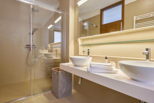 a bathroom with two sinks and a shower at Lake Front Casa Christina in Malcesine
