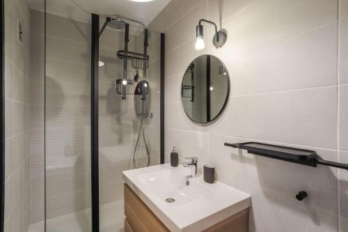 une salle de bain avec un lavabo et une douche dans l'établissement LE SÉVIGNÉ - Appartement cocooning à proximité du Thabor, à Rennes
