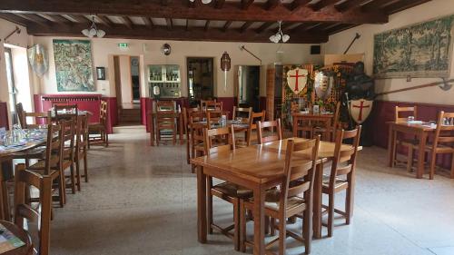 a dining room with wooden tables and chairs at Auberge le Cévenol in La Cavalerie