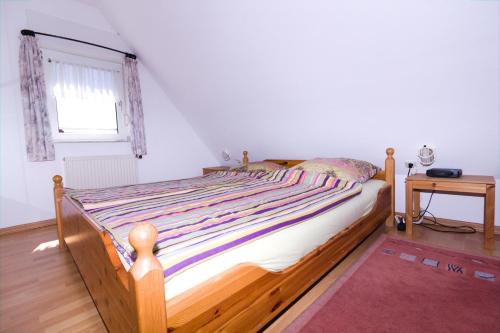 a bedroom with a bed with a wooden frame and a window at Lachmöwe in Dornumersiel