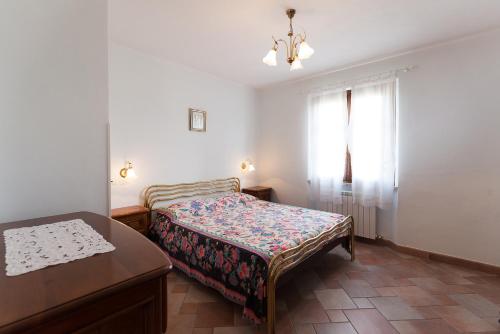 a bedroom with a bed and a table and a window at Casa Fiori di Pesco - Goelba in Marciana Marina