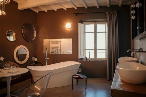 a bathroom with a large tub and a sink at B&B La Castellina in Abbadia San Salvatore