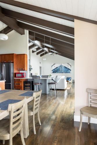 a kitchen and living room with a table and chairs at Sandbar Cedar Cottage on Lake Leelanau in Cedar