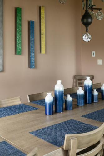 a table with blue vases sitting on top of it at Sandbar Cedar Cottage on Lake Leelanau in Cedar