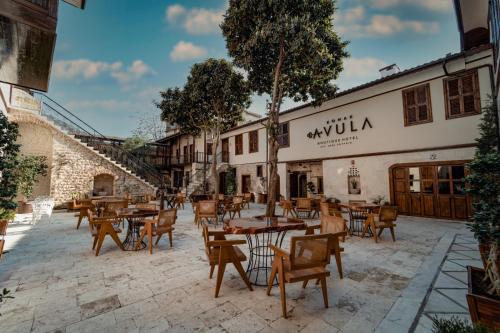 a patio of a restaurant with tables and chairs at Konak Avula Boutique Hotel in Hatay