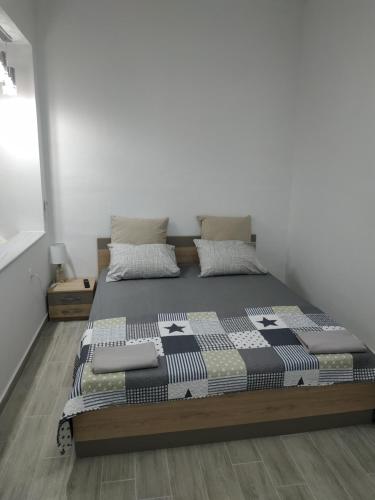 a large bed in a room with white walls at Ioanna Studio Διαμέρισμα κοντά στη θάλασσα. in Kolimbia