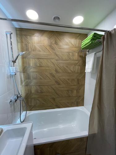 een badkamer met een douche, een bad en een wastafel bij “Same as Home apt”M.Zhusupa str. 284/1 in Pavlodar
