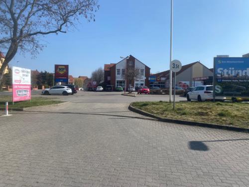 a street with cars parked in a parking lot at Apartment NV in Lutherstadt Eisleben